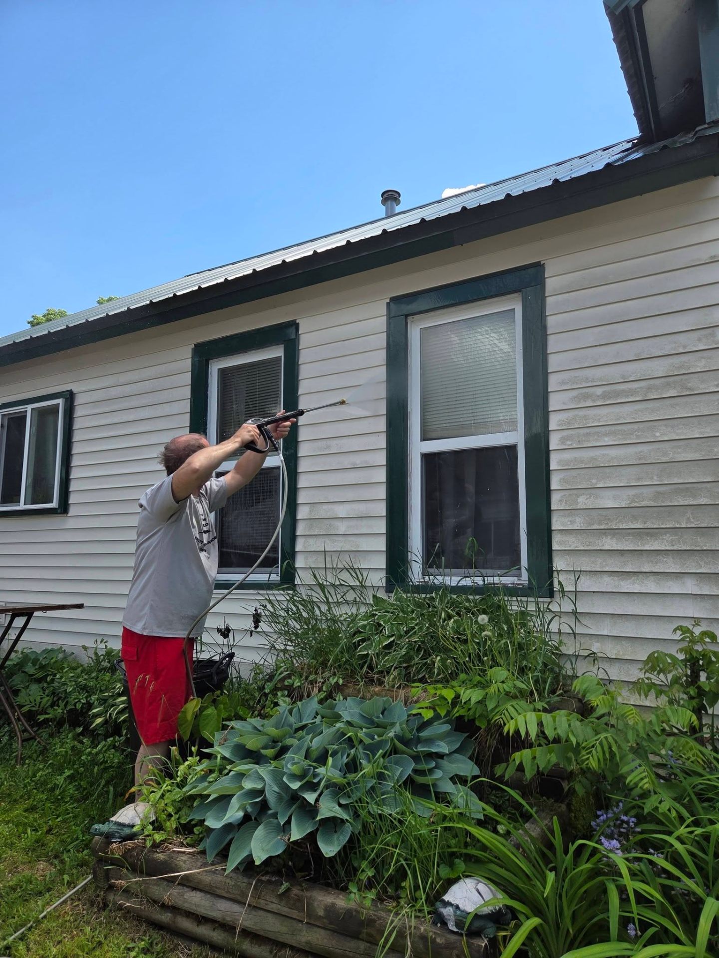 Power washing weathered exterior siding
